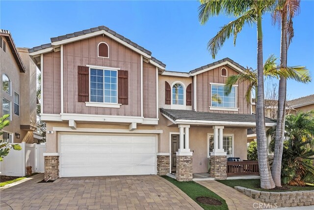 craftsman inspired home featuring a garage and a porch