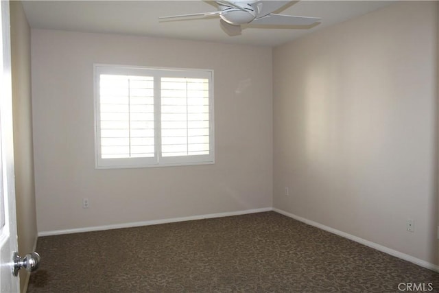 unfurnished room featuring ceiling fan and dark carpet