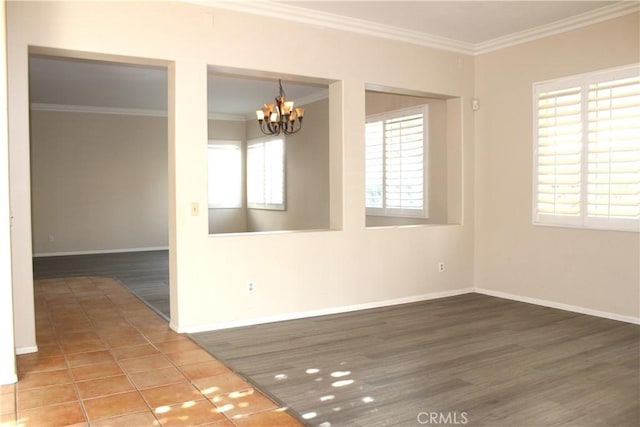 spare room featuring tile patterned floors, an inviting chandelier, and ornamental molding