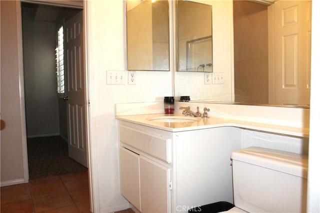 bathroom with tile patterned flooring, vanity, and toilet