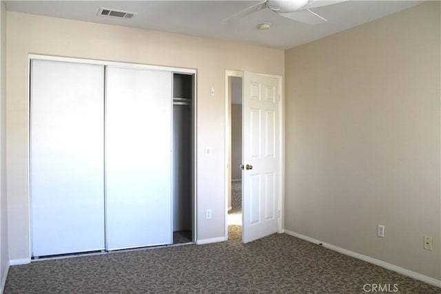 unfurnished bedroom with ceiling fan, carpet floors, and a closet