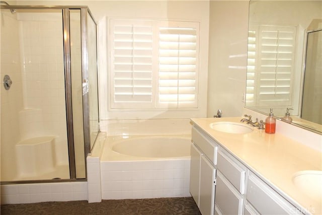 bathroom featuring vanity and shower with separate bathtub