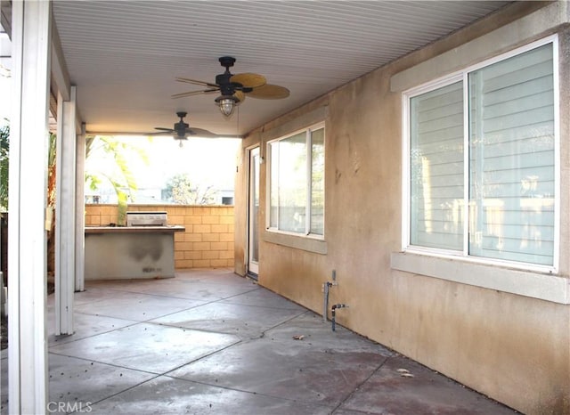 view of patio / terrace featuring ceiling fan and exterior kitchen