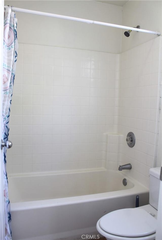 bathroom with shower / tub combo and toilet