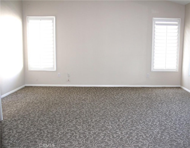 carpeted empty room featuring plenty of natural light