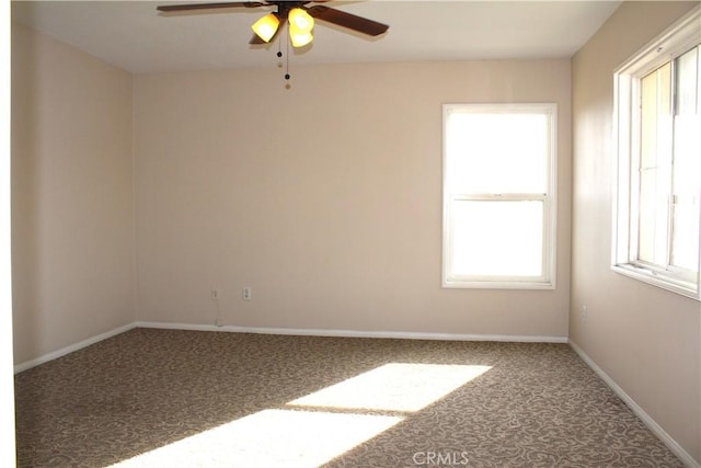 unfurnished room with ceiling fan and carpet floors