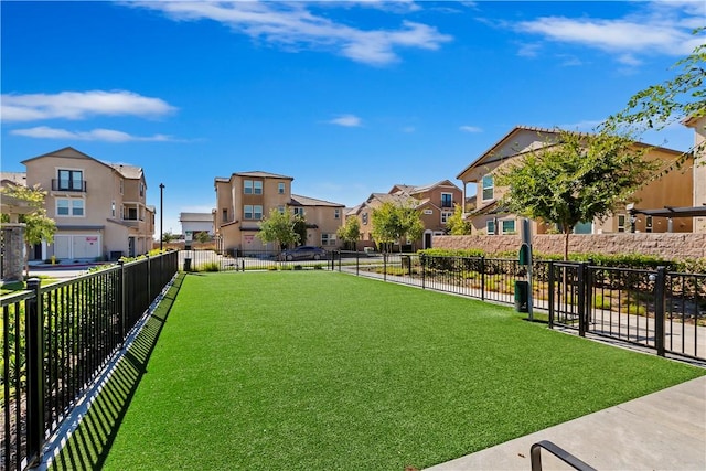 view of property's community with a lawn