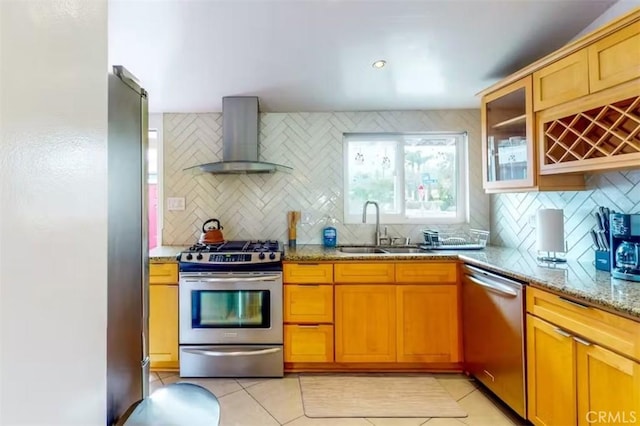 kitchen featuring backsplash, sink, wall chimney exhaust hood, and stainless steel appliances