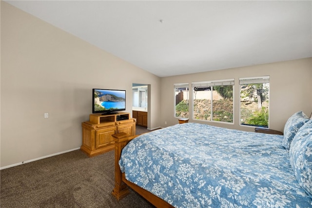 bedroom with lofted ceiling and dark colored carpet