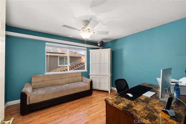 office with ceiling fan and light hardwood / wood-style flooring