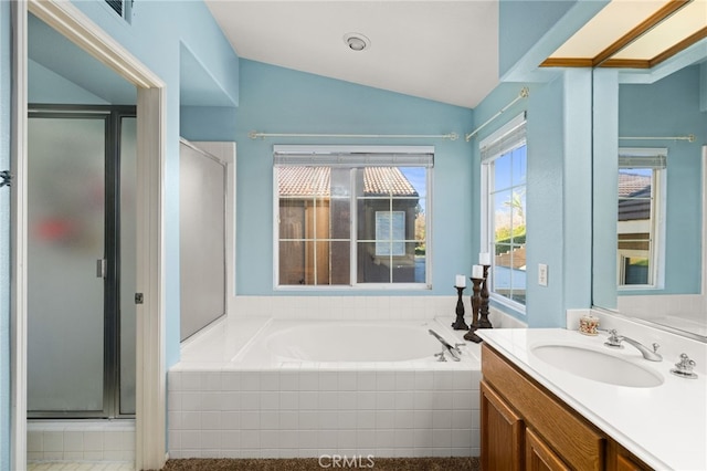 bathroom with vaulted ceiling, plus walk in shower, and vanity