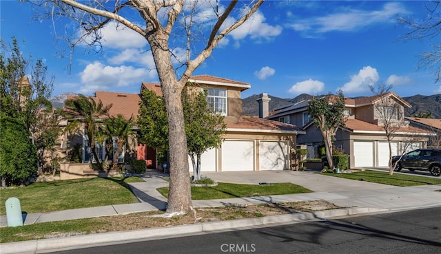 view of front of home with a front yard and a garage