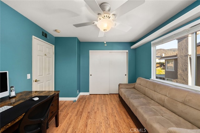 office space featuring light wood-type flooring and ceiling fan