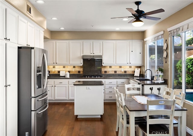 kitchen with sink, a center island, white cabinetry, dark hardwood / wood-style floors, and stainless steel refrigerator with ice dispenser