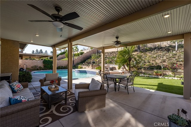 view of patio with ceiling fan, a fenced in pool, and an outdoor living space