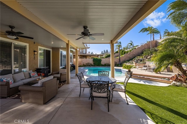 view of patio with ceiling fan, a fenced in pool, and outdoor lounge area