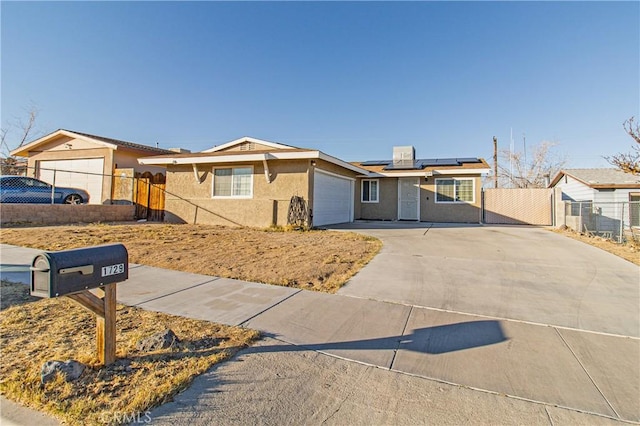 single story home featuring a garage and solar panels