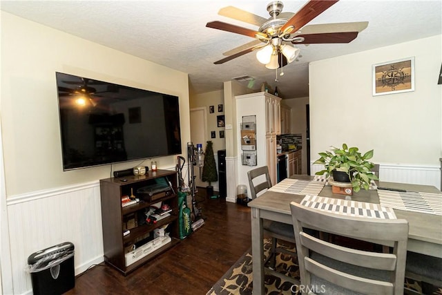 dining space with a textured ceiling and dark hardwood / wood-style flooring