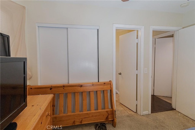 bedroom featuring a closet and light carpet