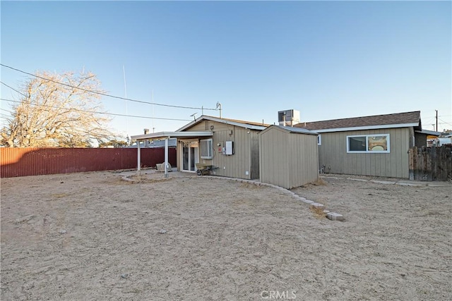 back of house featuring central AC unit