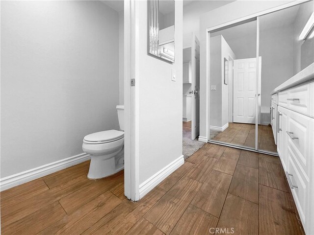 bathroom featuring hardwood / wood-style floors and toilet