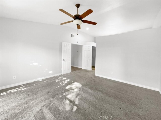 carpeted empty room with vaulted ceiling and ceiling fan