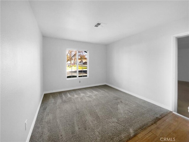 empty room with hardwood / wood-style floors