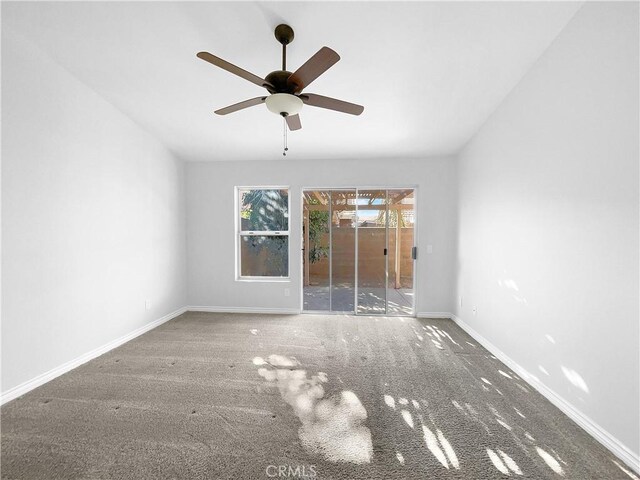 unfurnished room with ceiling fan and carpet flooring