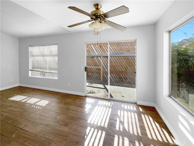 unfurnished room featuring dark hardwood / wood-style floors and ceiling fan