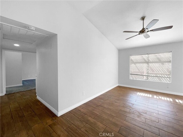 unfurnished room featuring dark hardwood / wood-style flooring, lofted ceiling, and ceiling fan