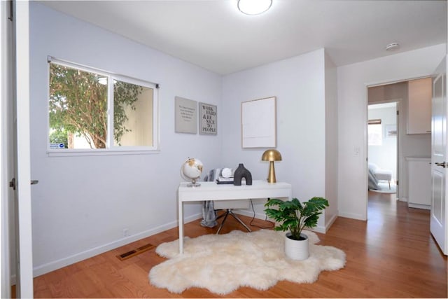 home office with wood-type flooring