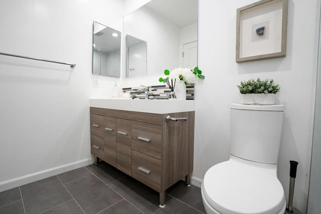 bathroom featuring vanity, tile patterned floors, and toilet