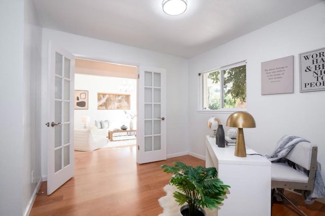 home office featuring french doors and light hardwood / wood-style flooring