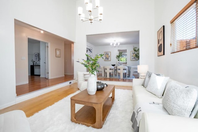 living room featuring hardwood / wood-style flooring and an inviting chandelier