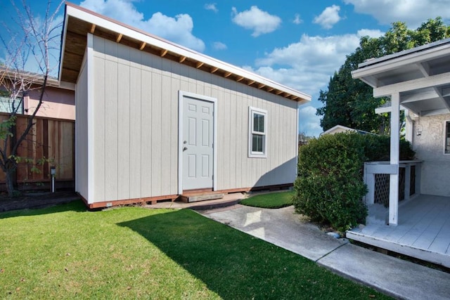 view of outbuilding featuring a yard