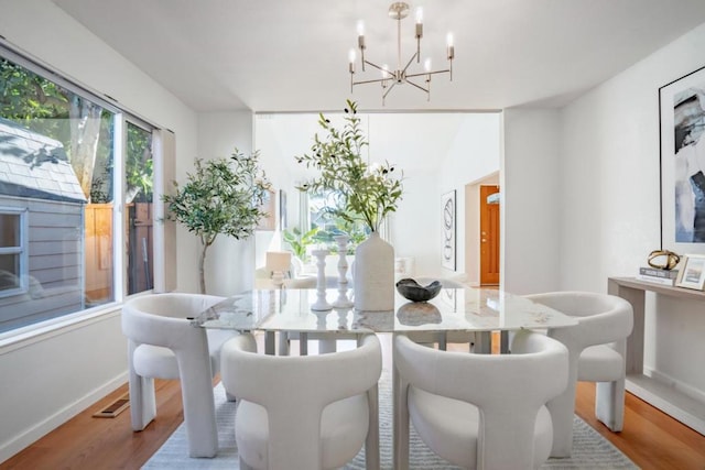 dining room featuring a notable chandelier and light wood-type flooring