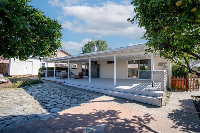 view of pool with a patio and a storage unit