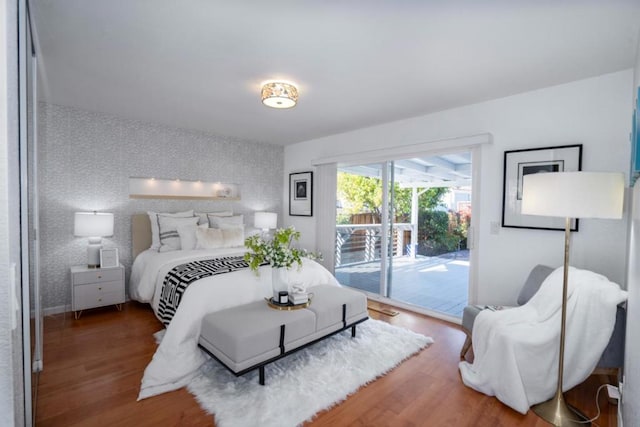 bedroom with wood-type flooring and access to exterior