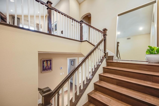 staircase with a high ceiling