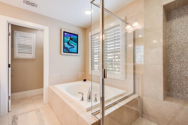 bathroom with tile patterned floors and shower with separate bathtub