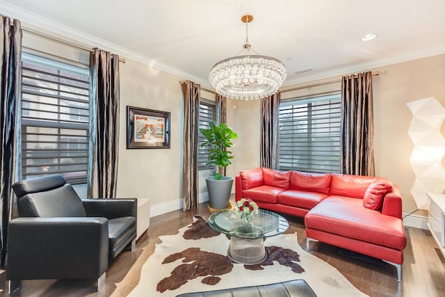 living room featuring crown molding, hardwood / wood-style flooring, and an inviting chandelier