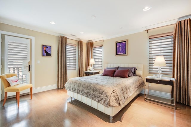 bedroom with light hardwood / wood-style flooring and ornamental molding