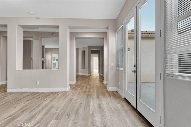 hall with light wood-type flooring