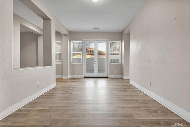 foyer featuring light hardwood / wood-style flooring and french doors