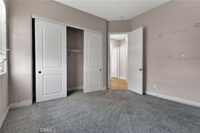 unfurnished bedroom with a closet and carpet