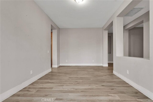 spare room featuring light hardwood / wood-style flooring