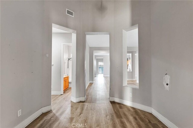 hallway with light hardwood / wood-style floors