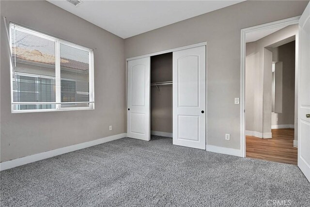 unfurnished bedroom featuring a closet and carpet