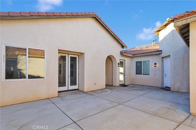 back of house with french doors and a patio area