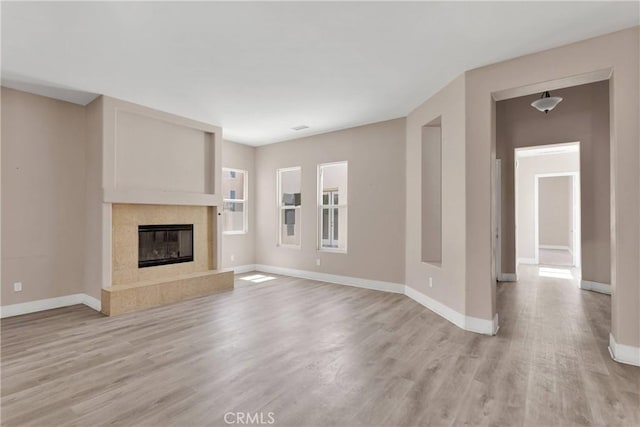 12573 Cabazon Ct, Apple Valley, CA 92308 - unfurnished living room featuring baseboards, a high end fireplace, and light wood-type flooring